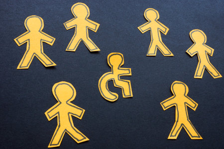 Figures with one in a wheelchair. Inclusivity and accessibility.の写真素材