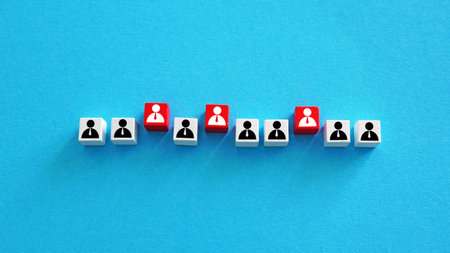 Employee figures with some highlighted in red. Staff selection.の写真素材