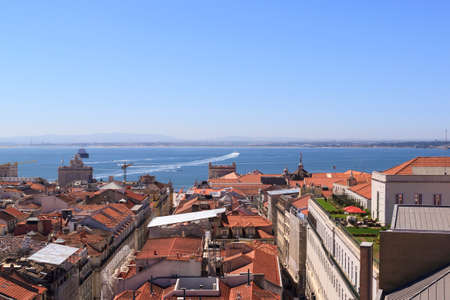 The view of the city from view point on a sunny summer day. The roofs of the houses and the river Tagus. Lisbon, Portugal.の写真素材