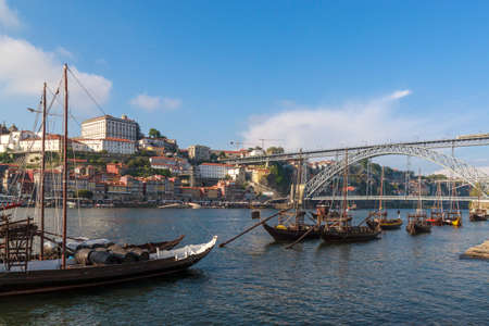 View of the Ribera and bridge Dom Luis I Bridge from Vila Nova de Gaia. The river Douro, Porto, Portugal. Colorful houses on the embankment.  Barrels of port on boats. Travel photography.のeditorial素材