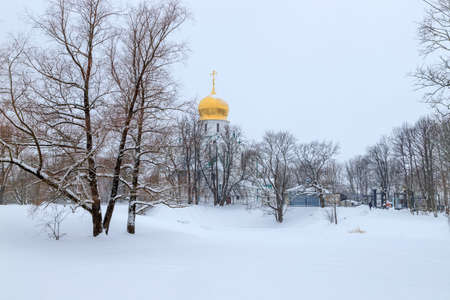 Winter snowy landscape. Snow-covered glade on a cold winter day. Snow on tree branches. Church with a Golden dome in the distance. Nature photography.の写真素材