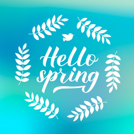Hello spring calligraphy lettering with floral wreath frame on green blue blurred background....