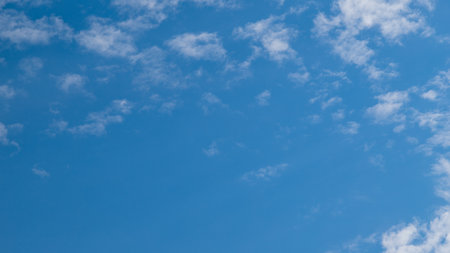 White clouds on blue sky. Fluffy cirrus clouds in summer sunny day. Nature cloudscape background with copy spaceの写真素材