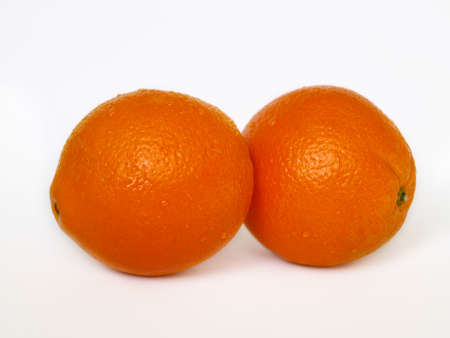 Two orange with water drops on white isolated background.の写真素材