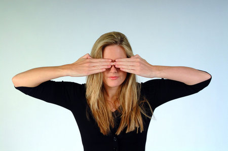 Woman with both hands over her eyes.