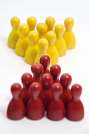 Red and yellow wooden markers meet. Shot on a white background with a narrow depth of field.の写真素材