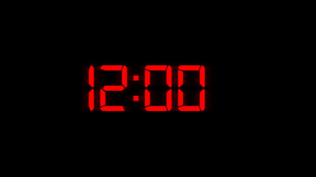 Red digital clock on a black background.の写真素材