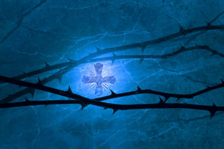 Shining marble cross over a marble ground, with bright and dark scratches, similar to the thorny rose lines, hovering in the front, photographed with a slightly glowing back light to achieve this light compostion                               の写真素材