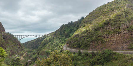 LOS SAUCES, SPAIN  APRIL 20, 2014  The longest single span bridge in Europe, built in 2004, avoids the narrow twisting road in the Barranco, which leads to Los Tilos in the Canary Island, la Palma のeditorial素材