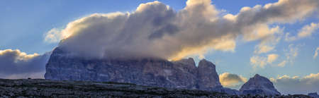 Mountain massif in the italian dolomites, the Croda dei Toni, in the Twelver, part of the Sextner Alps, viewed near the Three Peaks, at dawnの写真素材