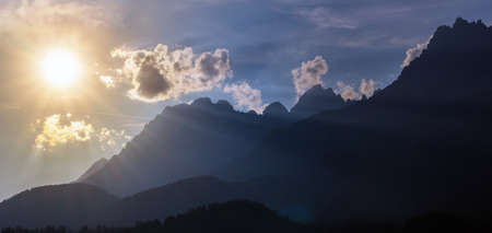Sunset rays at silhouettes of the Wilder Kaiser, a famous mountain range in northern Austriaの写真素材