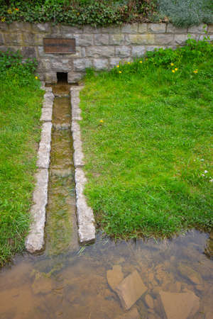 Tauber Well flowing from the origins, located in Wettringen, Bavaria, South Germanyの写真素材