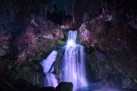 Illuminated night view of the Triberger Waterfalls, the highest in Germany, in the Black Forestの写真素材