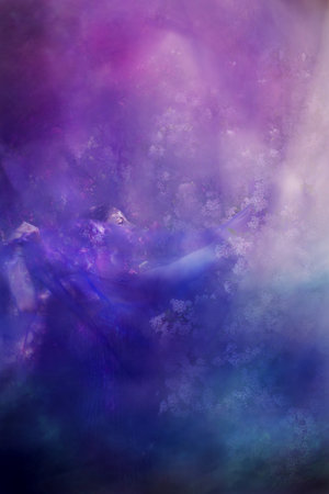 A woman is draped up behind a blue veil, trying to connect to springtime blossoms.の写真素材