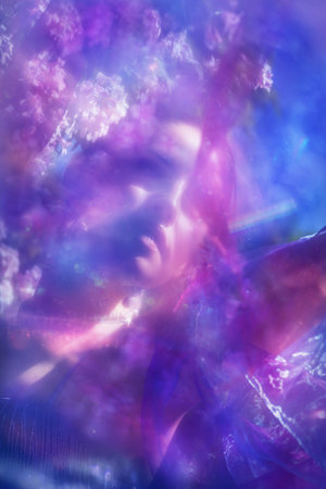 Beautiful female expression in springtime with a rainbow bokehの写真素材