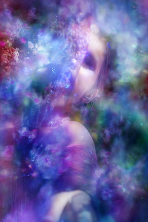 Young woman behind a sparkling veil, with bokeh and light texturesの写真素材