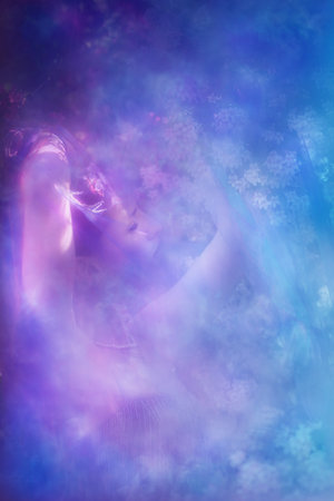 Young female expressing sensitivity with a glowing veil in front of a beauty bush at spring.の写真素材