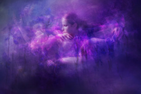 A dancing woman is moving closely through painterly Iris textures.の写真素材