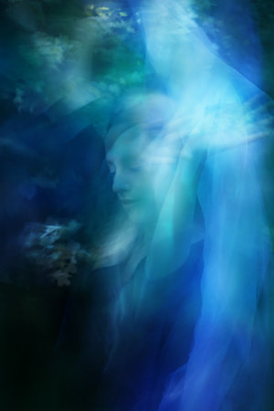 The hands of a dancer are touching an illuminated veil, captured in double exposure movement.の写真素材