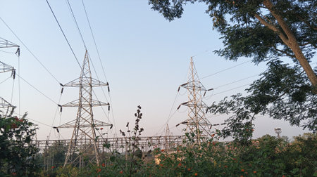 High-voltage power lines against the blue sky in the evening.