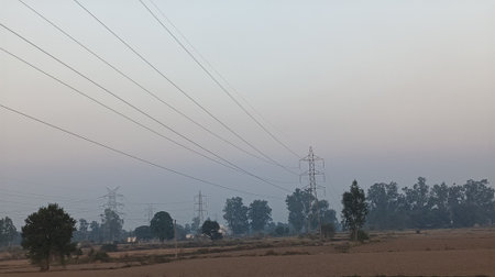 Electricity pylons and power lines in a rural area.