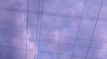 High-voltage lines and blue sky with white clouds in the evening