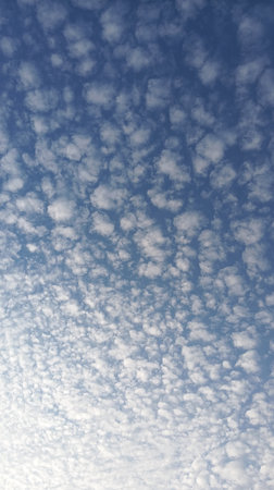 Clouds in the blue sky as an abstract background. Texture.