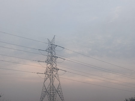 High voltage power lines in the evening. Power transmission tower. Electricity distribution station.