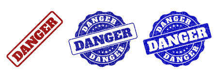 DANGER scratched stamp seals in red and blue colors. Vector DANGER signs with distress effect. Graphic elements are rounded rectangles, rosettes, circles and text labels.のイラスト素材