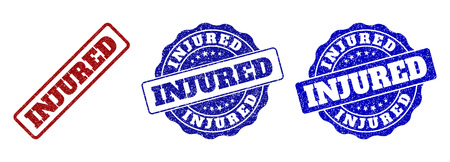 INJURED grunge stamp seals in red and blue colors. Vector INJURED labels with grunge surface. Graphic elements are rounded rectangles, rosettes, circles and text captions.のイラスト素材