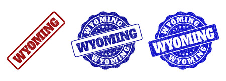 WYOMING scratched stamp seals in red and blue colors. Vector WYOMING imprints with grunge effect. Graphic elements are rounded rectangles, rosettes, circles and text tags.のイラスト素材