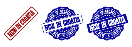 NEW IN CROATIA grunge stamp seals in red and blue colors. Vector NEW IN CROATIA imprints with grunge texture. Graphic elements are rounded rectangles, rosettes, circles and text captions.のイラスト素材