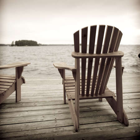 Adirondack chairs on deck, Muskoka, Ontario, Canada Adirondack chairs on deck, Muskoka, Ontario, Canada
