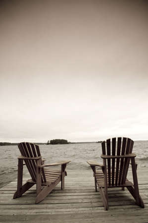 Adirondack chairs on deck, Muskoka, Ontario, Canada Adirondack chairs on deck, Muskoka, Ontario, Canada