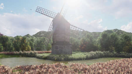 Traditional village windmill standing near the pond against the background of mountains and clouds. 3D Renderingの写真素材