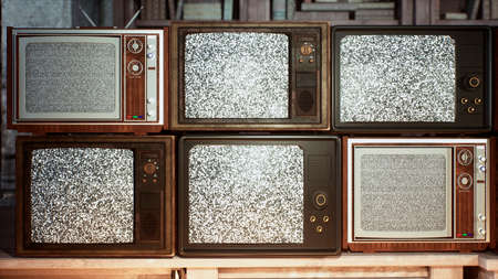 Several vintage TVs in an old building. TVs from the 70s and 80s, retro TVs with poor signal reception. Old televisions on an old table. 3D Rendering.の写真素材