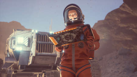 A woman astronaut works with a tablet on the surface of a unexplored planet. The woman was created using 3D computer graphics. 3D rendering.の写真素材