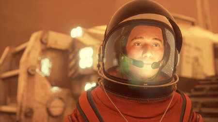Portrait of a brave male astronaut on a red alien planet surveying the landscape. The man was...