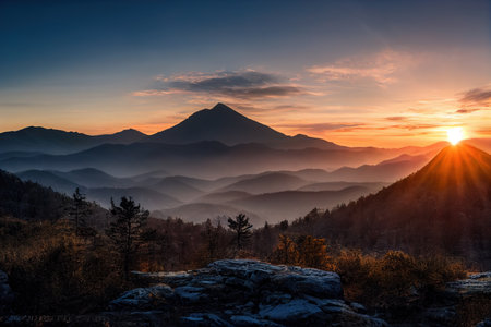 Beautiful ancient mountains at sunset, in the evening sunlight and in the fog. 3D rendering.の写真素材