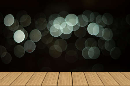 Empty table in front of blurry white light bokeh background.