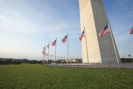 Wide angle view of the Washington Monument with American flags flying at the baseの写真素材
