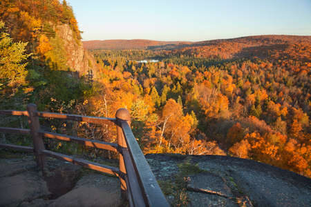 Trees in fall color, hills and lake viewed from a scenic overlook on Oberg Mountain in northern Minnesotaの写真素材