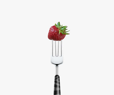 strawberry pierced by fork,  isolated on white background の写真素材