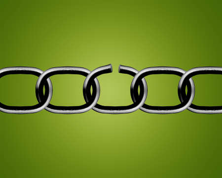 Broken metal chain parts on green background. の写真素材
