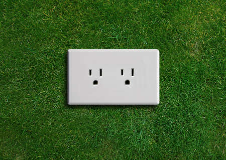 electricity  adapter on a green grassland, Green energy concept, Green power.
