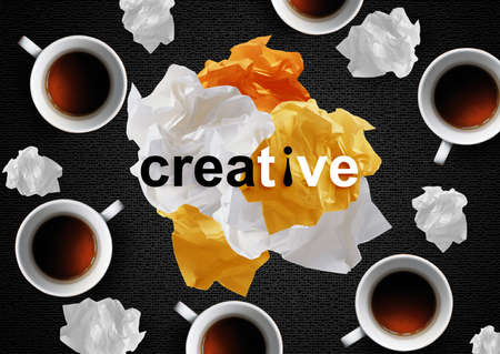 Crumpled colorful papers with coffee on black desktop.の写真素材