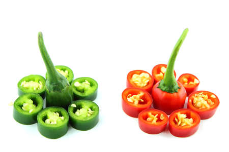 red and green hot chili pepper slices on a white background 