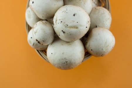 button mushrooms in straw basket, champignons. の写真素材