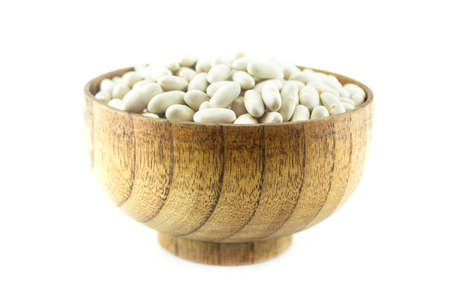 Pile Lima Bean in wooden plate isolated on white backgroundの写真素材