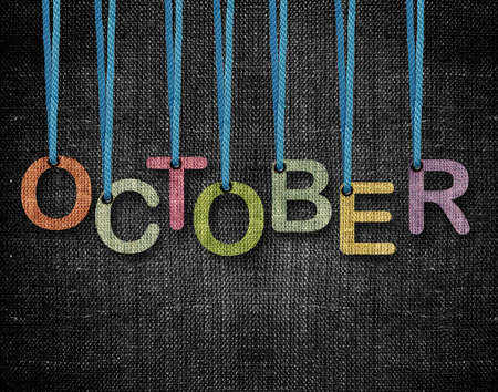 October letters hanging strings with blue sackcloth background.